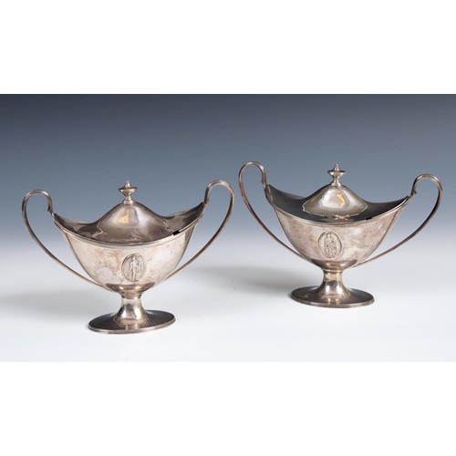 655 - A pair of late 18th century silver tureens and covers, of navette form, with twin reeded handles and... 