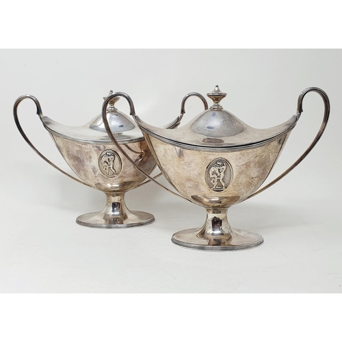 655 - A pair of late 18th century silver tureens and covers, of navette form, with twin reeded handles and... 