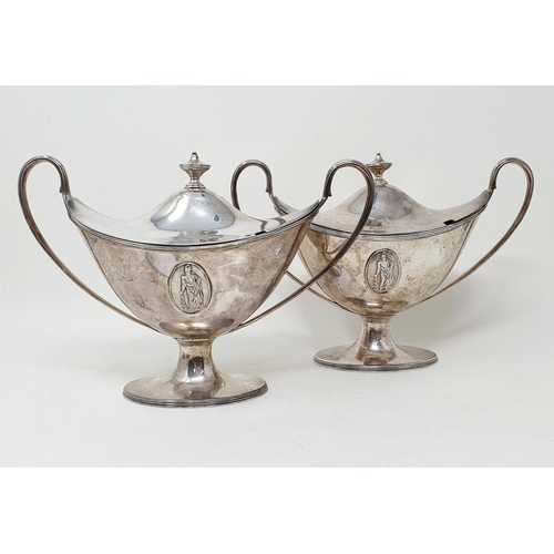 655 - A pair of late 18th century silver tureens and covers, of navette form, with twin reeded handles and... 