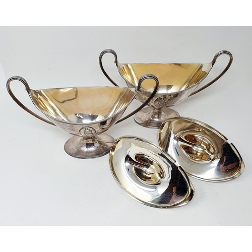 655 - A pair of late 18th century silver tureens and covers, of navette form, with twin reeded handles and... 