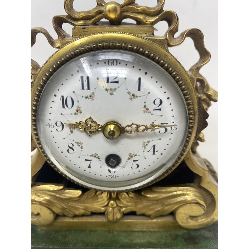 716 - A 19th century mantel clock, with a painted enamel dial, with Arabic numerals, 6 cm diameter, to a s... 