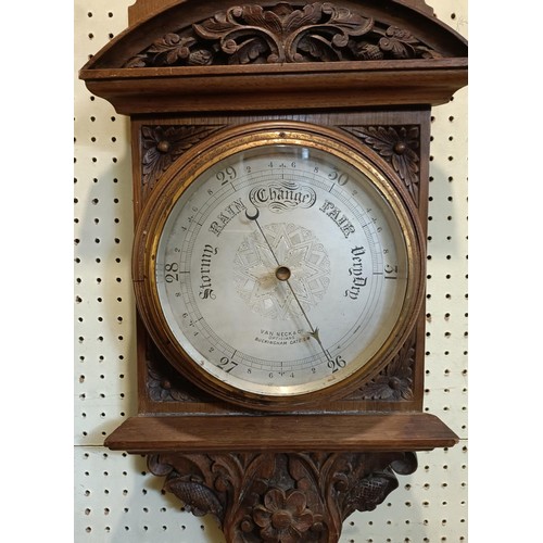 718 - A barometer, with a retail stamp for Van Neck & Co, Opticians, Buckingham Gate, in a walnut case, 10... 