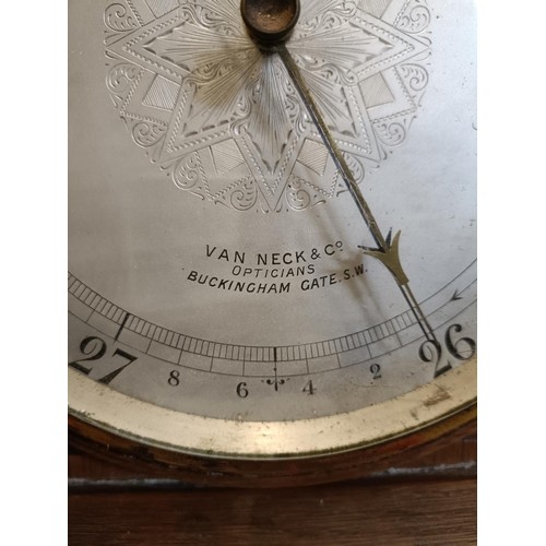 718 - A barometer, with a retail stamp for Van Neck & Co, Opticians, Buckingham Gate, in a walnut case, 10... 