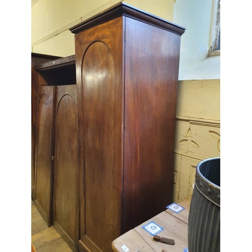 729 - A 19th century mahogany wardrobe, the centre section with two cupboard doors, to reveal slides, two ... 