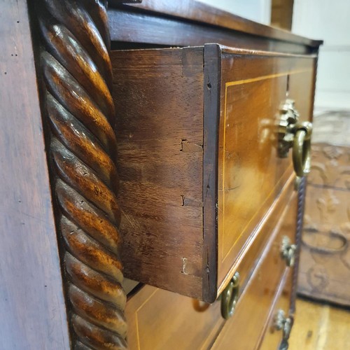 738 - A Channel Islands mahogany chest, having two short and three long drawers, flanked by spiral turned ... 