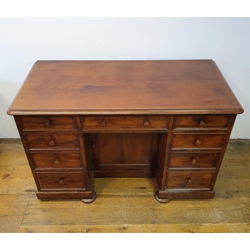 740 - A mahogany kneehole desk, having a seven drawer configuration, with a cupboard door to kneehole, 124... 