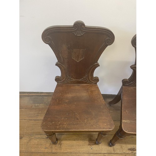 793 - A pair of 19th century mahogany hall chairs (2)