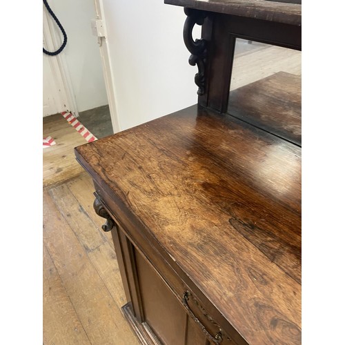 802 - A 19th century rosewood chiffonier, with a raised mirrored back, the base having a drawer and two cu... 