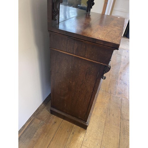 802 - A 19th century rosewood chiffonier, with a raised mirrored back, the base having a drawer and two cu... 