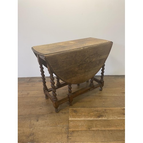 806 - An oak table, 65 cm diameter, a work box, a drop leaf table, four chairs, a set of three metal garde... 