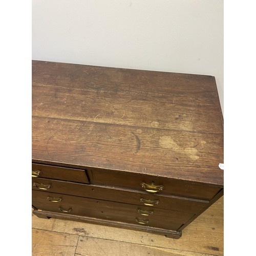 832 - A George III oak chest, having two short and three long drawers, 85 cm wide