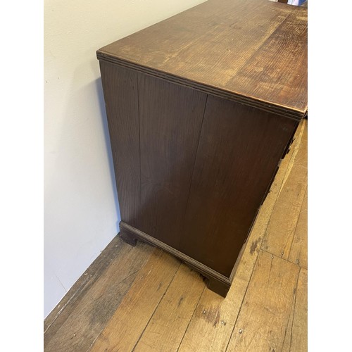 832 - A George III oak chest, having two short and three long drawers, 85 cm wide