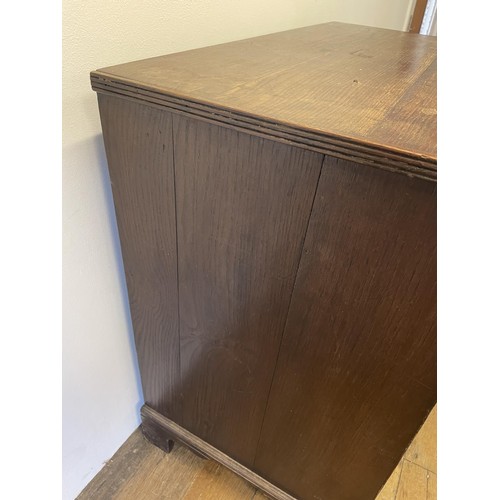 832 - A George III oak chest, having two short and three long drawers, 85 cm wide