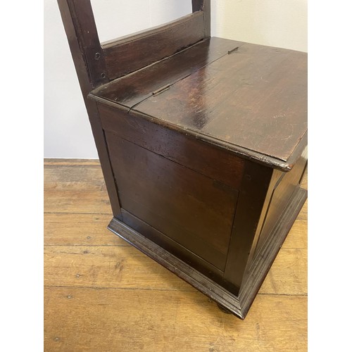 833 - An oak box seat, with a raised open back, 109 cm high x 60 cm wide