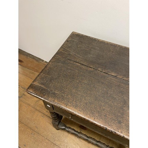 835 - An 18th century oak side table, with a single frieze drawer, on bobbin turned legs, 54 cm wide