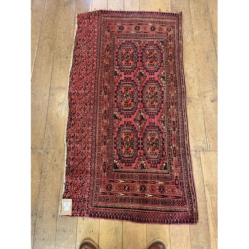 838 - An Afghan red ground rug, 152 x 82 cm and an Art Deco style robe (2)