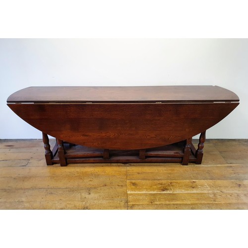 844 - A large 18th century style oak double gateleg table, 230 cm wide