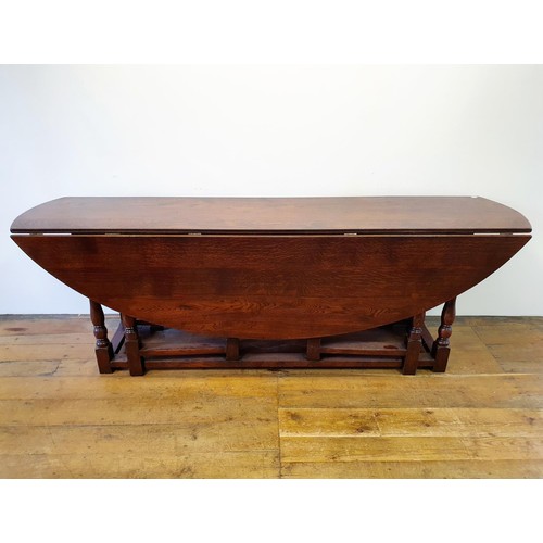 844 - A large 18th century style oak double gateleg table, 230 cm wide