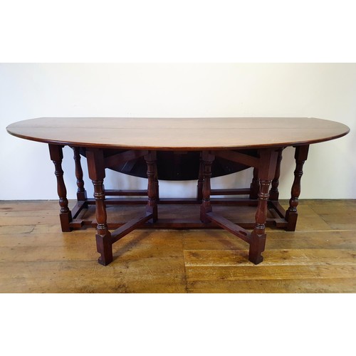 844 - A large 18th century style oak double gateleg table, 230 cm wide