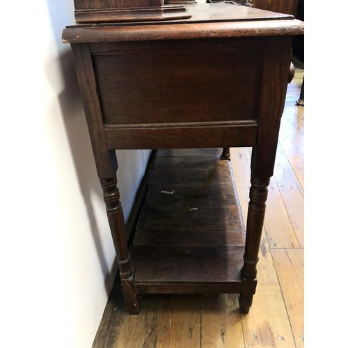 783 - An oak dresser, having a later two tier plate rack above a base with three frieze drawers and a potb... 