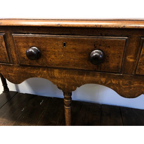 783 - An oak dresser, having a later two tier plate rack above a base with three frieze drawers and a potb... 