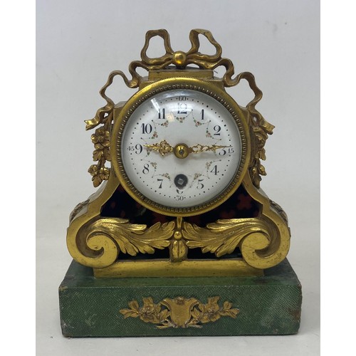 357 - A 19th century mantel clock, the 6 cm diamete enamel dial with Arabic numerals, in a gilt metal case... 