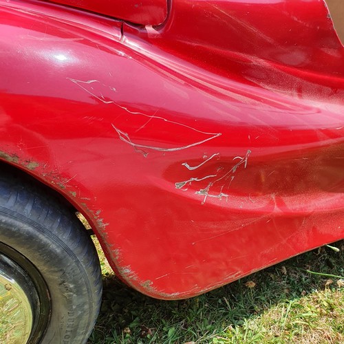 65 - An Austin J40 childs red painted pedal car, numbered 28052 on the boot floor