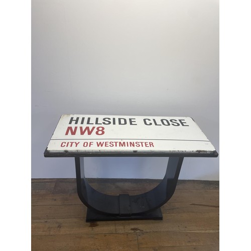 101 - An enamel street sign, Hillside Close NW8, City of Westminster, set into the top of a table, 107 cm ... 