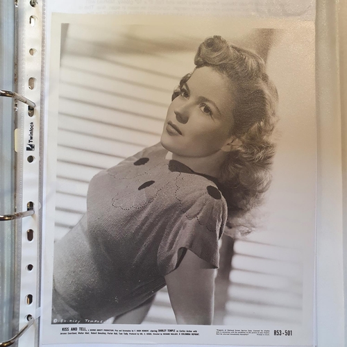 25 - An album of film portrait photographs and lobby cards, to include Bonnie Baker, Dean Martin, Sally B... 