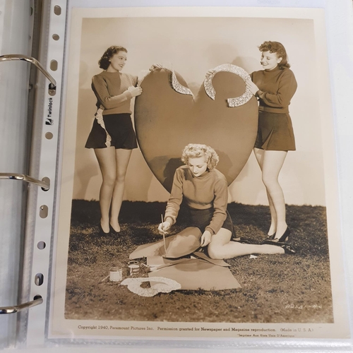 27 - An album of 1930s and 1950s film portrait photographs, and lobby cards, to include Joan Marion, Andr... 