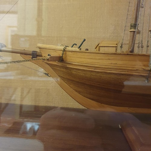 70 - A model of a two masted schooner, in a display case, 103 cm wide 
Provenance:  Hand built by the ven... 