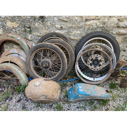 236 - A motorcycle frame, two fuel tanks, assorted mudguards and wheels (qty)