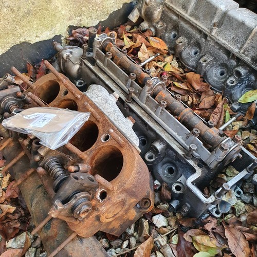 241 - Assorted cylinder heads and other engine parts, including Austin 7  (qty)
Provenance: Removed from a... 