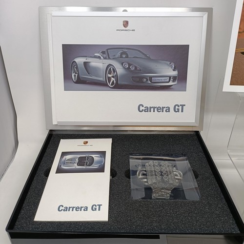 96 - A model of a Porsche Carrera GT engine, with a video cassette and book, in an aluminium presentation... 