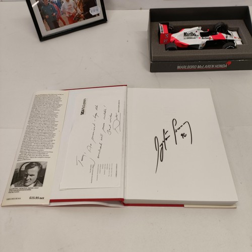 108 - Assorted Ayrton Senna memorabilia, to include a McLaren book signed by Ayrton Senna, a model of a Mc... 