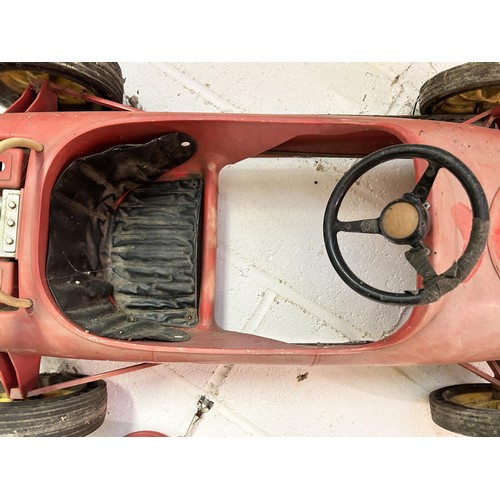 70 - A child's Ferrari pedal car, some parts missing, and a child's race type helmet
Being sold without r... 