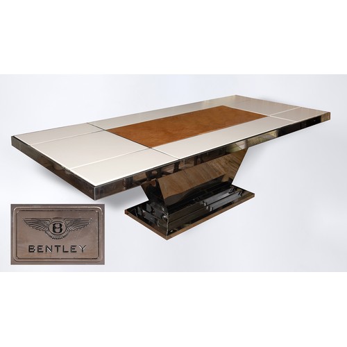 132 - A Bentley Home dining table, in cream leather, walnut and chrome, the rectangular top inset with pan... 