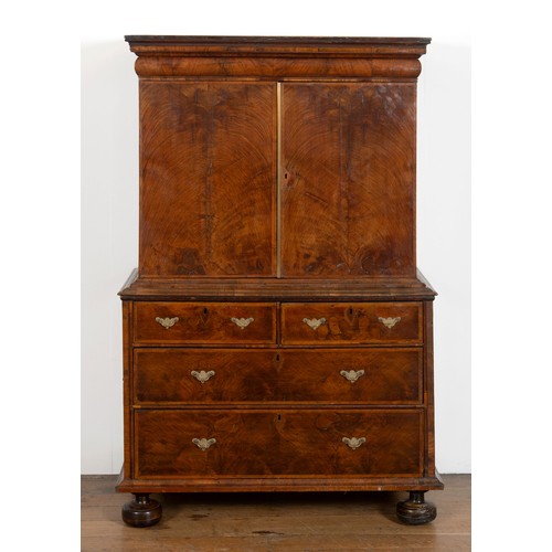 481 - An 18th century walnut cabinet on chest, with two cupboard doors, to reveal an interior with drawers... 