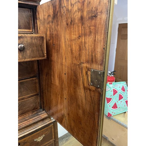 481 - An 18th century walnut cabinet on chest, with two cupboard doors, to reveal an interior with drawers... 