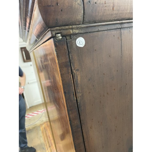 481 - An 18th century walnut cabinet on chest, with two cupboard doors, to reveal an interior with drawers... 