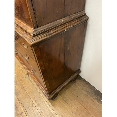 481 - An 18th century walnut cabinet on chest, with two cupboard doors, to reveal an interior with drawers... 