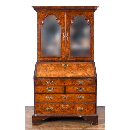 491 - An 18th century walnut bureau bookcase, the top having two mirrored doors, to reveal a fitted interi... 