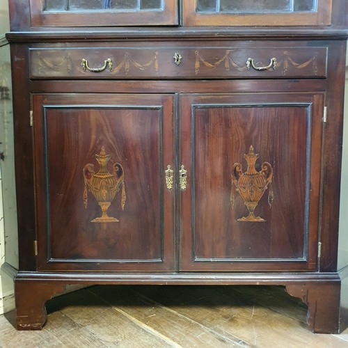 557 - A late 19th/early 20th century mahogany corner cabinet, with marquetry inlay decoration, the top hav... 