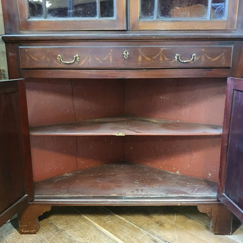 557 - A late 19th/early 20th century mahogany corner cabinet, with marquetry inlay decoration, the top hav... 