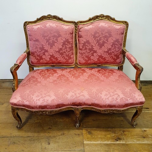 545 - An early 20th century carved wood and gilt framed double armchair, with a padded back, arms and seat... 