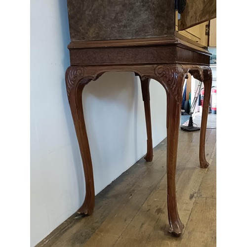 556 - A walnut and brass bound cocktail cabinet, raised on carved cabriole legs, 85 cm wide