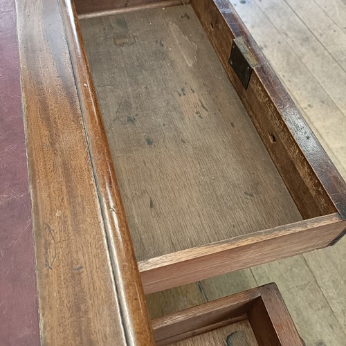 565 - A mahogany pedestal desk, having a nine drawer configuration, 120 cm wide