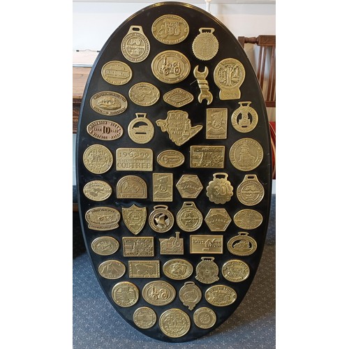 160A - An oval panel, applied vaious rally brass plaques, 106 cm high, and another similar, 90 cm high (2)