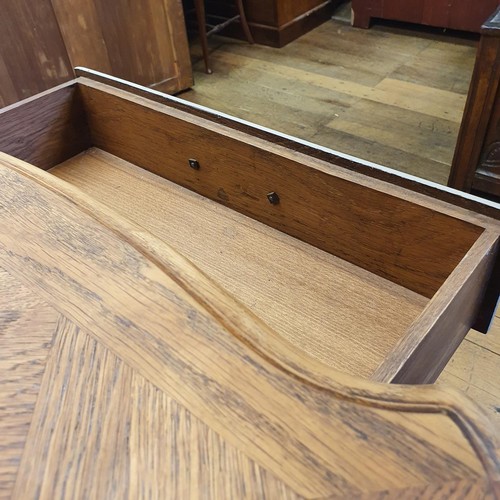 486 - A French oak serpentine sideboard, with a painted front, having two cupboard doors, flanked by two d... 