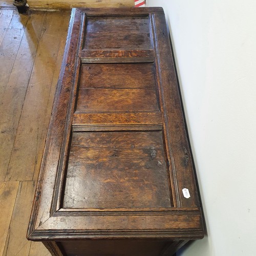 485 - An 18th century oak coffer, with a later carved front, 120 cm wide